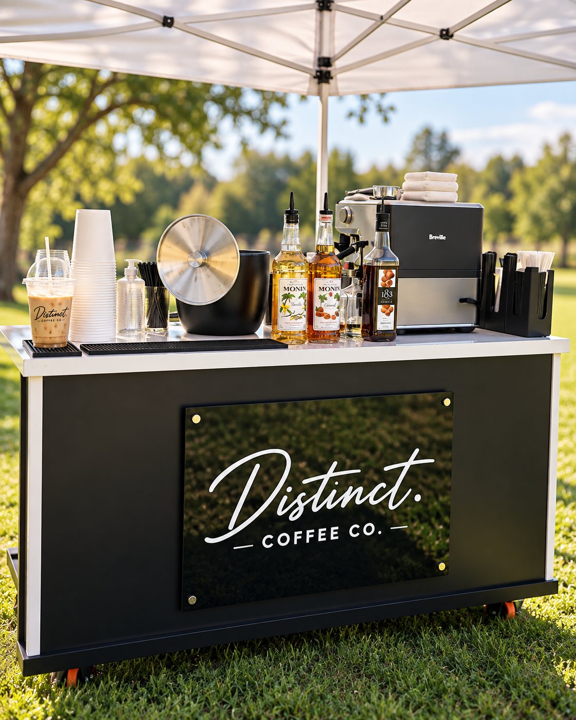 Distinct. Coffee Co. cart set up under a tent at an outdoor event